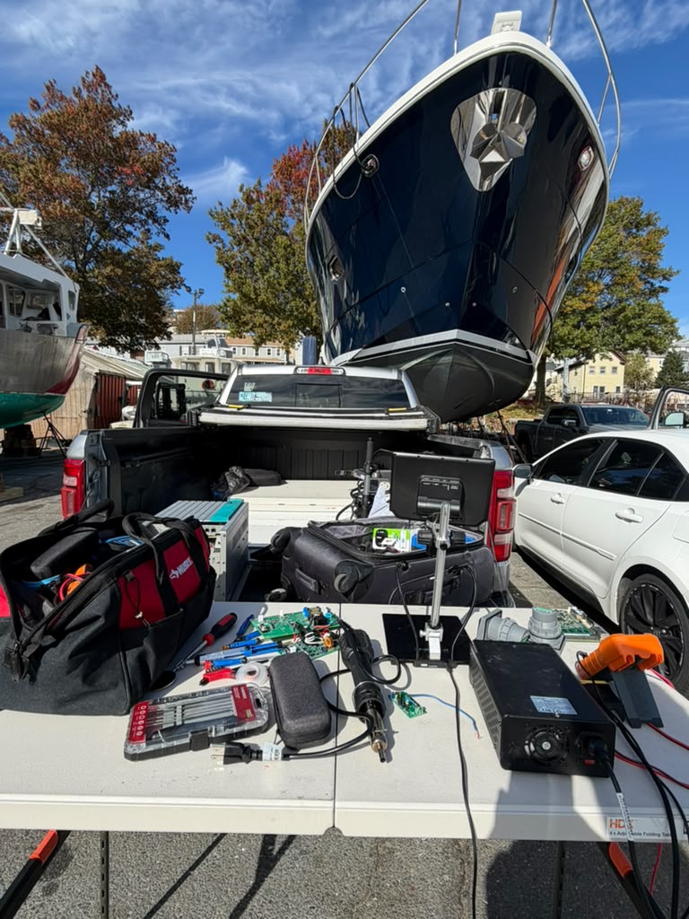 Mobile repair bench set up under a yacht hull in the boatyard